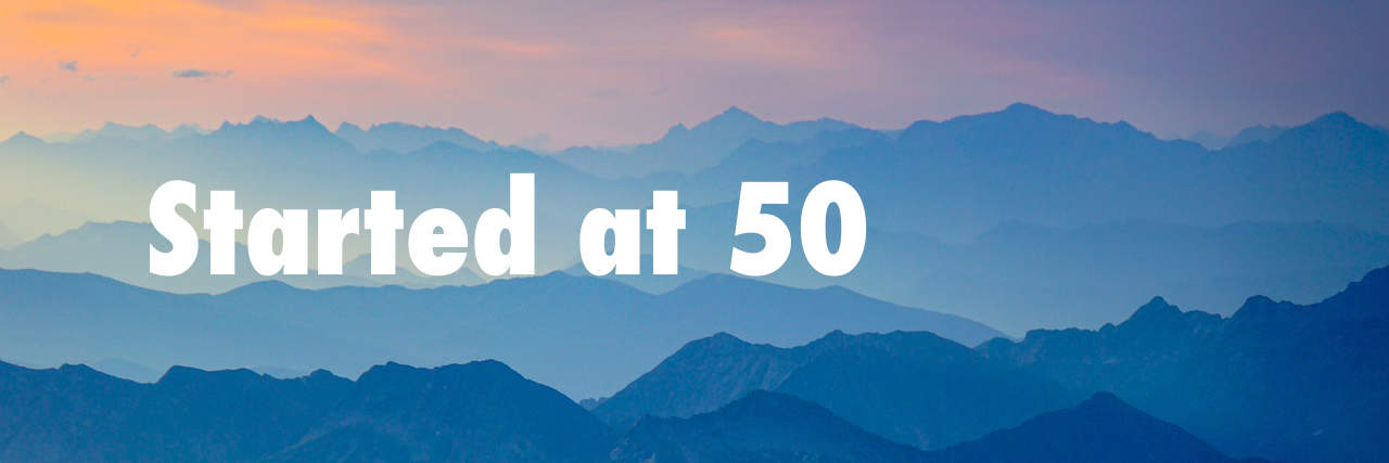 Finding new horizons: a journey begins at 50 amidst the serene mountain silhouettes at dawn.