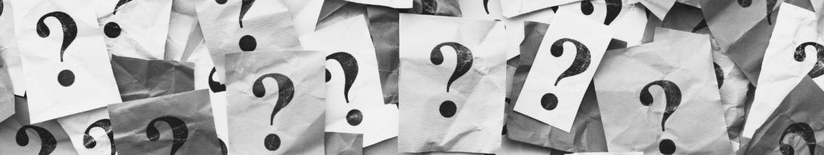 A collage of overlapping pieces of paper, each featuring a large black question mark printed on it. The papers are wrinkled and varied in shades of white and gray, creating an abstract and mysterious visual effect.