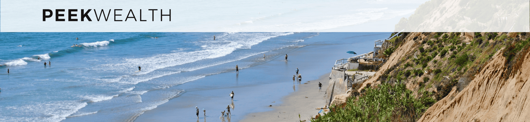 A scenic beach with people enjoying the water and sand. A rocky cliff with greenery rises on the right side of the image. The text 
