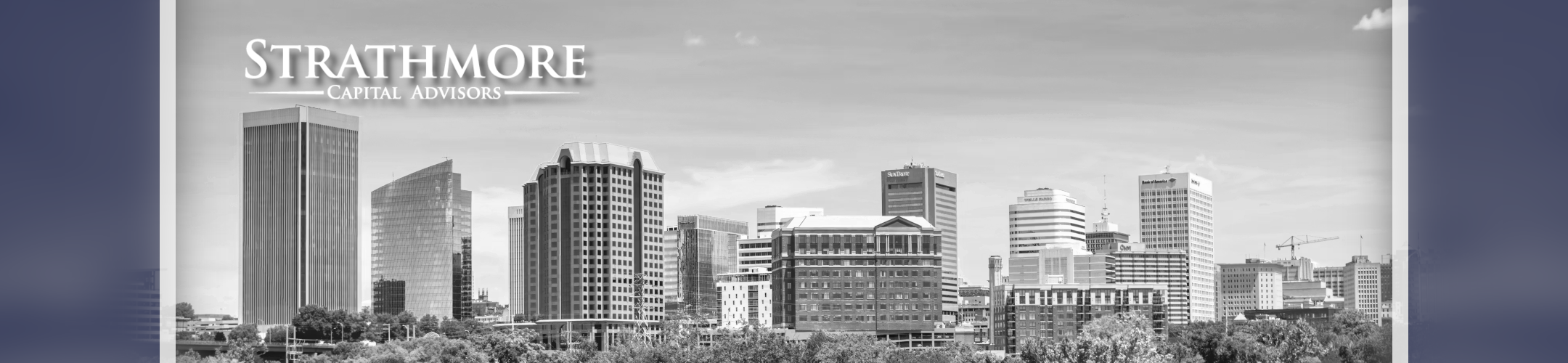 Black and white image of a city skyline with modern and tall buildings. The text 